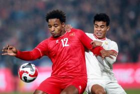 Vietnam&#039;s Nguyen Xuan Son (left) controls the ball during their 5-0 win over Myanmar in an Asean Championship Group B match.