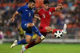 Thailand&#039;s Kritsada Kaman (left) and Singapore&#039;s Ikhsan Fandi challenging for the ball during the 2026 Fifa World Cup qualifiers.