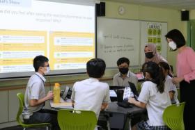 Minister of State for Education Sun Xueling (right) observing a cyber-wellness lesson at Compassvale Secondary School on Jan 18, 2022.