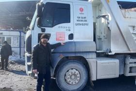 Mr Kazim Erdogan with the truck he uses to deliver items such as stoves for the needy, despite having lost family members in the earthquake.