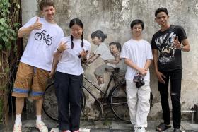 (From left) Lithuanian artist Ernest Zacharevic, siblings Tan Yi and Tan Kern, and Mohammad Shahrul Aiman Mohamed in Penang.