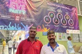 Indian nationals and colleagues Mr Rajamama Santhoshkumar (left) and Mr Vaiyapuri Krishnan attending the New Year’s Eve celebrations at Kranji Recreation Centre on Dec 31.