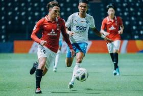 Urawa Red Diamonds' Ayumu Ohata dribbles away from Lion City Sailors winger Hafiz Nor.