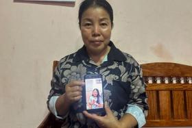 FILE PHOTO: Bunyarin Srijan, the mother of a Thai hostage released as part of a hostages-prisoners swap deal between Hamas and Israel, holds her phone showing an image of her daughter, Natthawaree Mulkan, during an interview at her home in Khon Kaen, Thailand November 25, 2023. REUTERS/Napat Wesshasartar/File photo