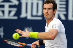 FILE PHOTO: Andy Murray of Britain hits a return to Tommy Robredo of Spain during their men's singles final match at the Shenzhen Open tennis tournament in Shenzhen, Guangdong province September 28, 2014/File Photo