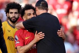 FILE PHOTO: Soccer Football - Premier League - Liverpool v Wolverhampton Wanderers - Anfield, Liverpool, Britain - May 19, 2024 Liverpool manager Juergen Klopp embraces Mohamed Salah after his last match as Liverpool manager REUTERS/Phil Noble/File Photo