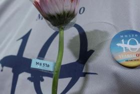 A family member of the missing Malaysia Airlines flight MH370 holds a flower during a remembrance event marking the 10th anniversary of its disappearance, in Subang Jaya, Malaysia March 3, 2024. REUTERS/Hasnoor Hussain/File Photo