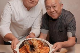 Chef Marvas Ng (left) of Path and Chef Ang Song Kang with their Chefs&#039; Harmony Pen Cai for Chinese New Year. 