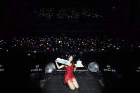 K-pop idol Solar poses with fans at the Capitol Theatre on July 27 during her concert in Singapore.