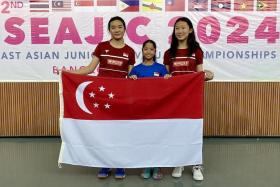 (From left) Singapore squash players Ong Zhe Sim, Kareena Sashikumar and Jacintha Han won their respective events at the South-east Asian Junior Individual Squash Championships.