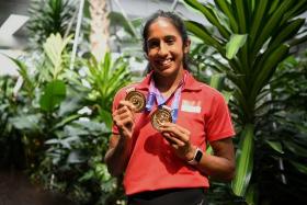 Shanti Pereira posing with her Asian Athletics Championships gold medals at Changi Airport on July 17, 2023.
