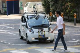 A self-driving electric vehicle being tested on the road in University Town at the National University of Singapore.