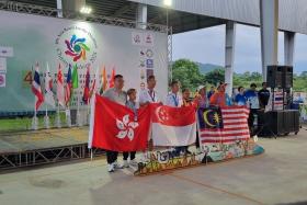 Koh Kwee Boon (fourth from left) and his director Gary Goh (third from left) struck gold in the B2 men's singles event at the Asia Bowls for the Disabled Championships.