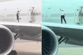 In a viral video, a flight attendant is seen dancing and posing for a photo on the wing and another crew member strikes bodybuilding poses.