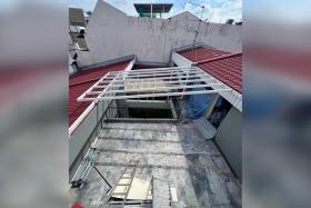 Home owner Ng Jun Quan removed a portion of the roof and the roof gutter, converting the area into an open terrace, and installed a roofing frame.