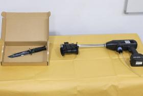 An improvised flamethrower (right) and a knife were seized at the scene of the incident. 