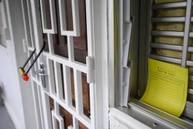 A note placed by the police instructing people not to remove the lock outside the unit at Block 125 Ang Mo Kio Avenue 6, where a 66-year-old man was arrested for suspected murder, on Nov 29.