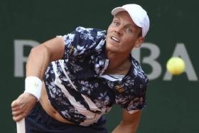 Czech Republic&#039;s Tomas Berdych returns the ball to Spain&#039;s Roberto Bautista Agut during their French tennis Open third round match at the Roland Garros stadium in Paris on May 30, 2014.