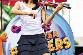 UNIVERSAL MUSIC: Ms Eileen Chai is a former national gymnast who teaches violin. For her, busking is a way to display her passion for music.