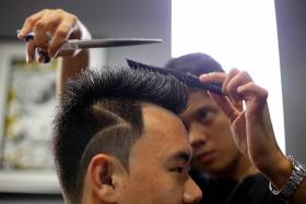 HAIR-RAISING: Mr Yap having his Cristiano Ronaldo-inspired cut.