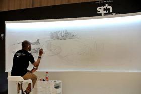 LIVE DRAWING: Stephen Wiltshire drawing Singapore&#039;s cityscape from memory on the first day of the live drawing exhibition See The Big Picture at Paragon yesterday. He will be there until Sunday.