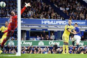 SO TERRY-BLE: Chelsea captain John Terry can only look as Everton&#039;s Kevin Mirallas heads the Toffees&#039; first of three goals past Thibaut Courtois. 