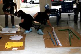 Police collecting evidence at the void deck of the block. 