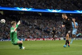 GLORIOUS FINISH: Francesco Totti (right) chips the ball over Man City goalkeeper Joe Hart for his landmark goal.