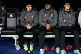 RESTED: (From left) Steven Gerrard, Glen Johnson and Jordan Henderson starting the midweek loss to Real Madrid on the bench.
