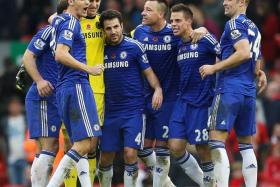 BLUE FORCE: Chelsea players celebrating their victory over Liverpool, thanks to the winner from Diego Costa.  