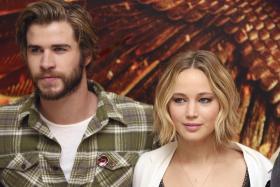 Jennifer Lawrence with &#039;The Hunger Games: Mockingjay Part 1&#039; cast member Liam Hemsworth at the London photo call in her stylish hairdo. 
