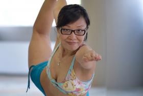 BALANCE AND CONTROL: Ms Diane Lee showing one of the 26 postures in Bikram yoga - the Standing Bow Pulling Pose.