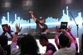 TOP DJS: Partygoers having a great time at Kallang Wave Mall as they dance to the infectious beats spun by 50 top local DJs.