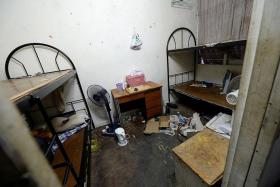MESSY: One of the 13 rooms in the three-storey house that Mr Chen, a Chinese national, lived in. All of them had bunk beds.