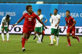 Myanmar&#039;s Shine Thrua after scoring against Indonesia in Group A of the 28th SEA Games football tournament.