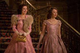 Sarah Gadon (R) plays Princess Elizabeth with Bel Powley (L) as Princess Margaret