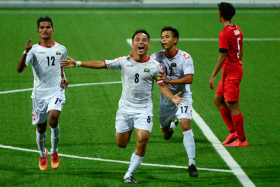 Myanmar&#039;s Tun Nay Lin (No. 8) celebrates after scoring his team&#039;s first goal against Singapore.