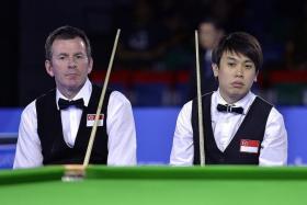 LOSS FOR WORDS: Singapore&#039;s English billiards doubles pair Peter Gilchrist (left) and Chan Keng Kwang (right) wondering how they let a  90-48 lead slip in the final frame.  