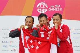 Singapore shooters Gai Bin, Lim Swee Hon and Poh Lip Meng celebrate their gold medal win in the men&#039;s 50m pistol team event of the 28th SEA Games.