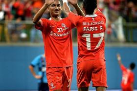 BACK ON SONG: Safuwan Baharudin (left, celebrating with Faris Ramli) after scoring a crucial goal by switching from defence to attack.