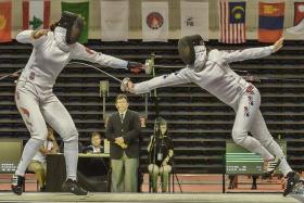 TAKE THAT: South Korea&#039;s Choi Eun Sook (right) scoring a point against China&#039;s Sun Yujie in the last round of the women&#039;s epee team final yesterday.