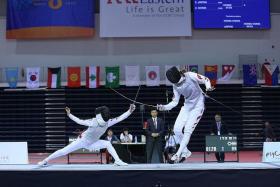 TAKE THAT: South Korea&#039;s Lim Seung Min (left) striking towards China&#039;s Gong Yu in the women&#039;s team foil final at the OCBC Arena.