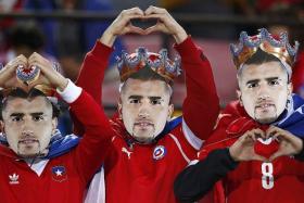 LONG LIVE THE KING: Chile fans don masks of their team&#039;s star player Arturo Vidal at the Copa America on home soil.