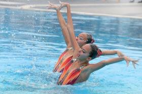STRIKE A POSE: Synchronised swimmers Carolyn Rayna Buckle (front) and Miya Yong Hsing competing in the duet category at the National Schools Synchronised Swimming Championships.