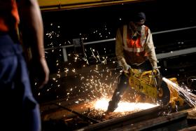 A member of SMRT’s Track Renewal Team operates a rail cutter to slice through the tracks. 