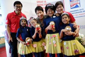 CHARITY: From left, Dr Khoo Kah Siang, CEO (Singapore), Great Eastern Life, Minister in the Prime Minister&#039;s Office Grace Fu and CEO, Great Eastern Financial Advisers Jesslyn Tan with girls from Lee Kong Chian MINDS Gardens School in their yellow tutus which cost $5 apiece.