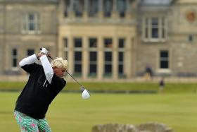 COLOURFUL: American golfer John Daly (left), wearing garish pink and green pants, teeing off from the 18th tee during the first round on Thursday.