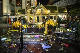Experts investigate at the Erawan shrine, the site of a deadly blast in central Bangkok August 17, 2015.