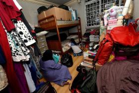 CRAMPED: Madam Herni Fadhillah Saad and her daughter are sharing a bedroom (above) in her mother&#039;s flat while her son sleeps in the living room.