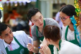 Singaporean MasterChef Asia contestant Lennard Yeong (second from left) was in the green team, which cooked Malay cuisine for Lau Pa Sat diners. 